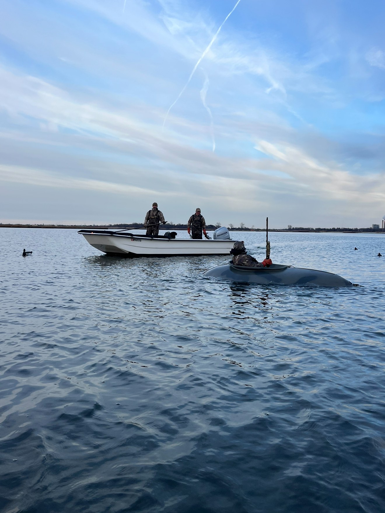 Hunters in layout boat on Long Island bay
