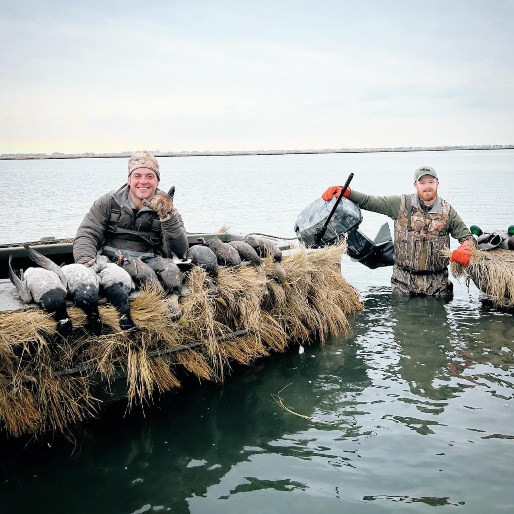 Hunters in layout boat with brant on Long Island